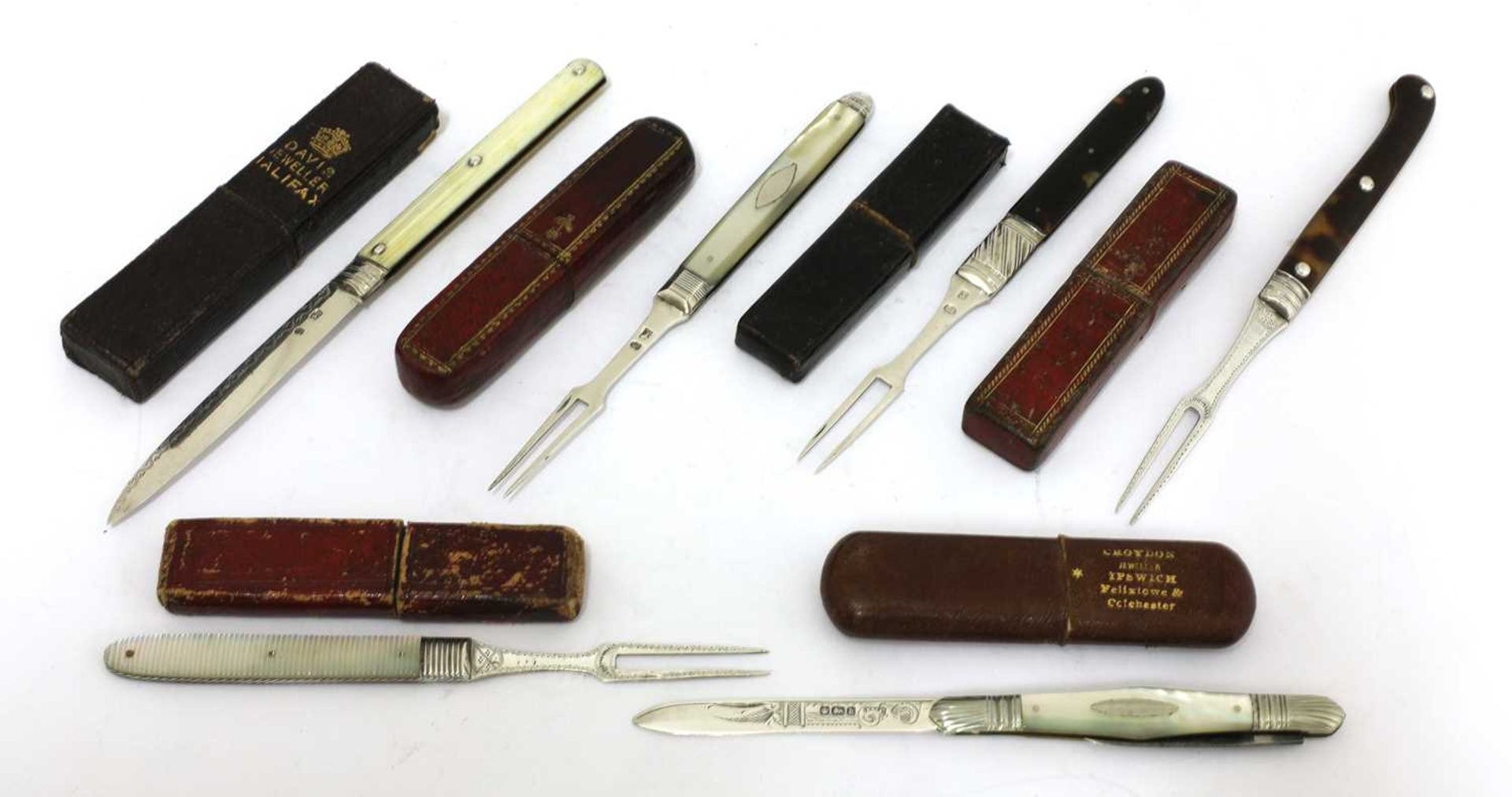 Six silver-mounted folding fruit knives and forks in cases,