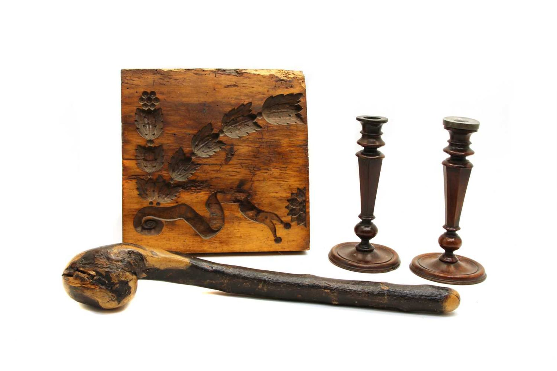 A pair of turned wooden candlesticks,