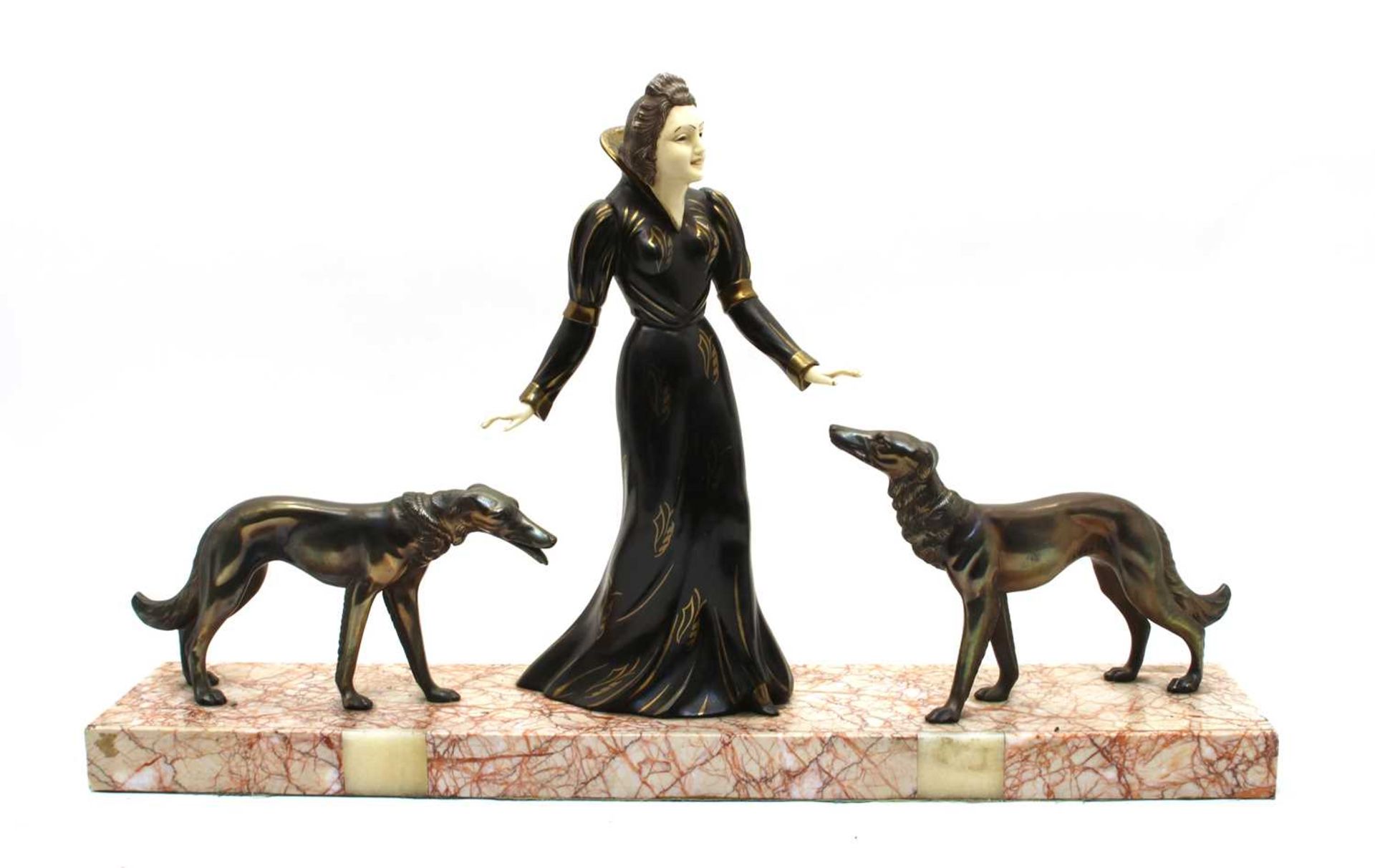 An Art Deco design bronzed group of a woman with two hounds,