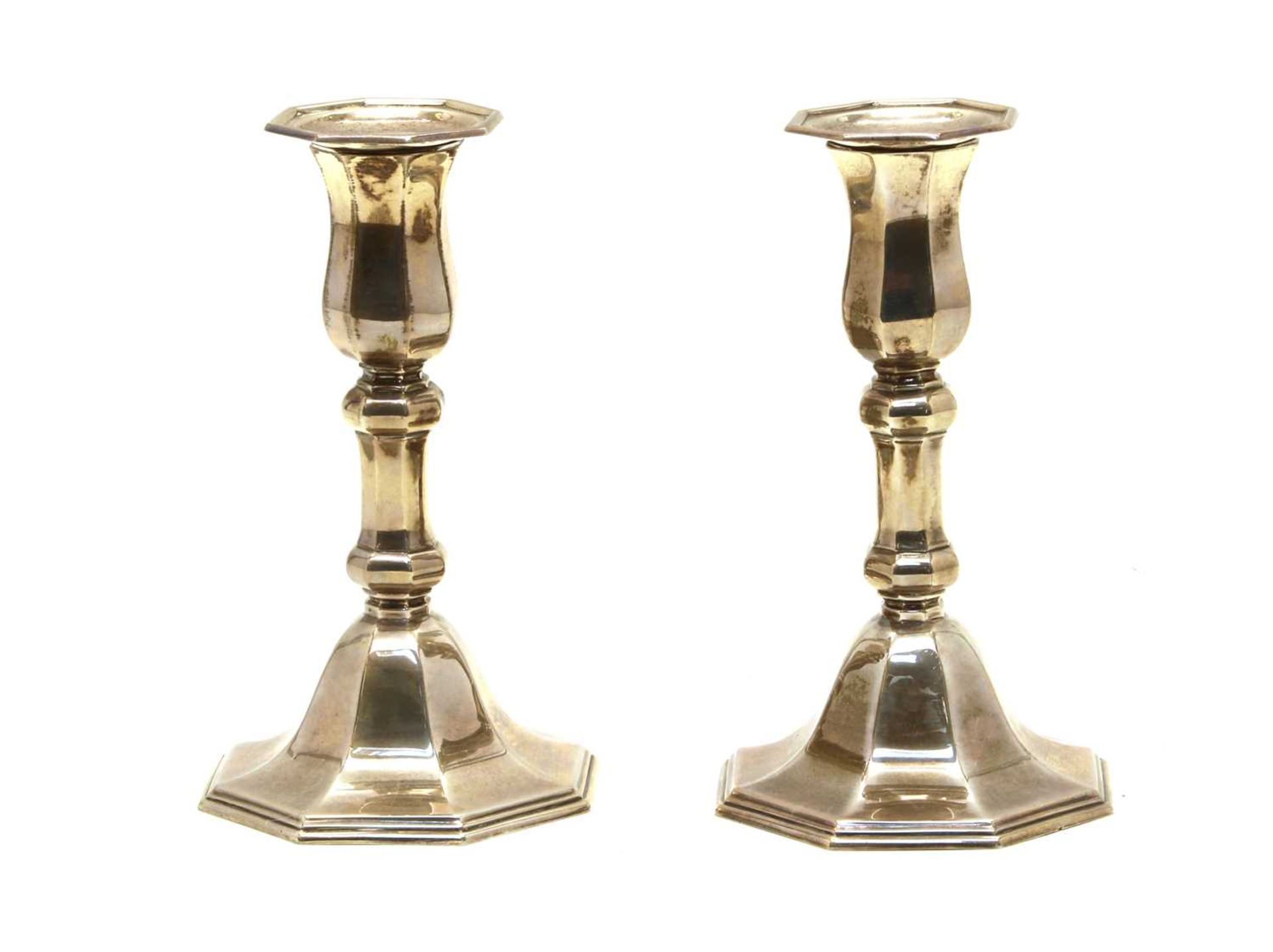 A pair of silver dwarf candlesticks