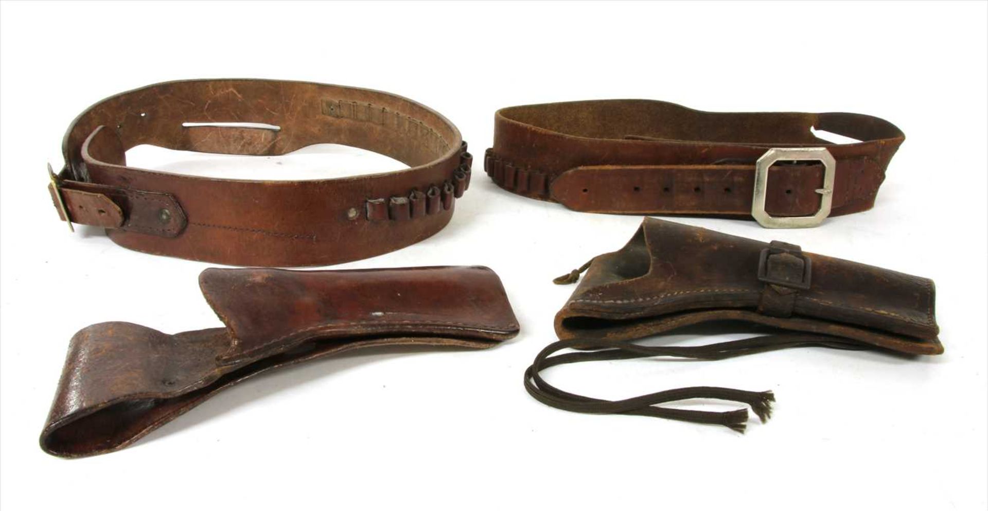Three leather holsters and two belts