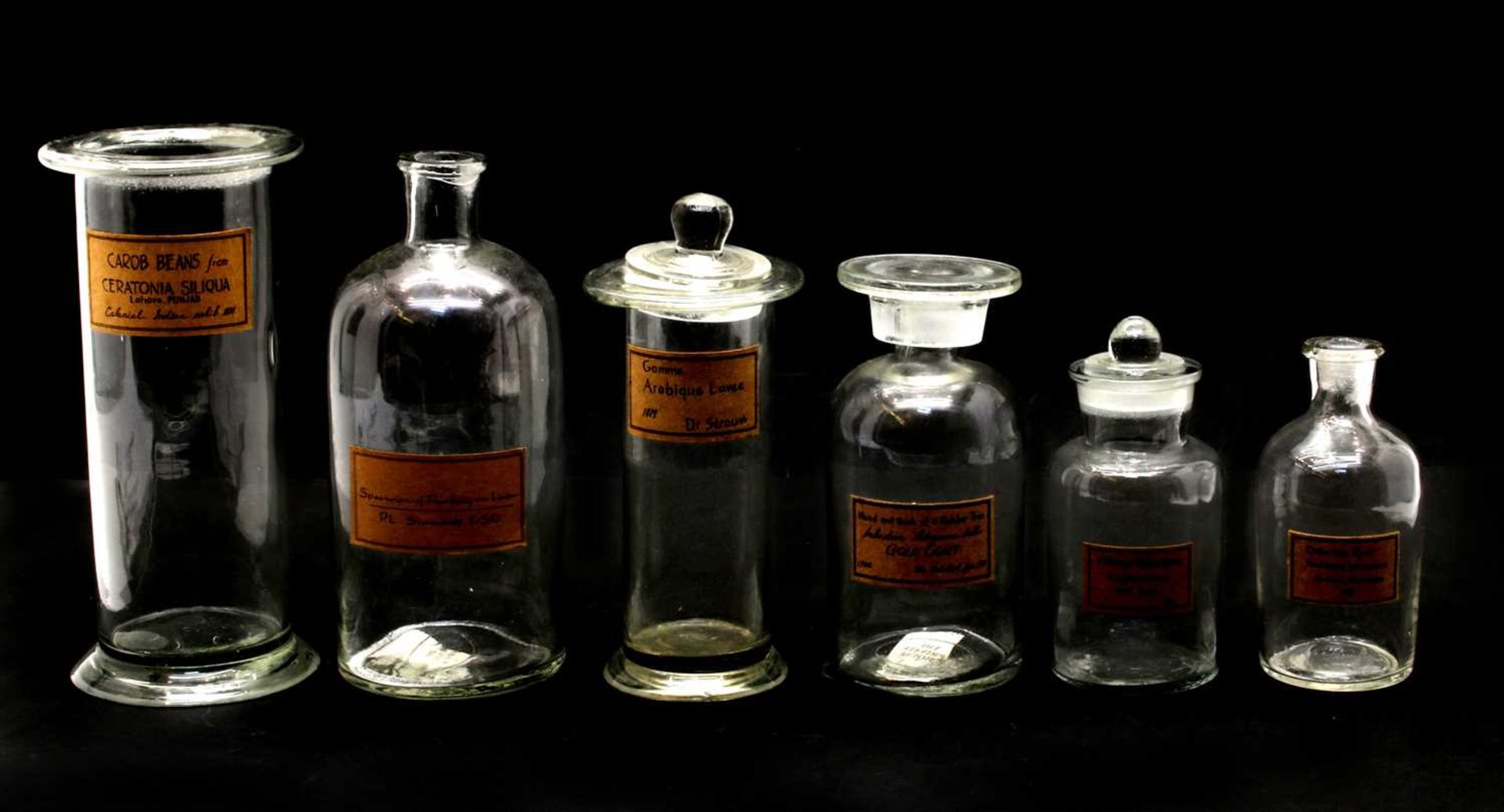 A collection of various modern apothecary jars of varying sizes