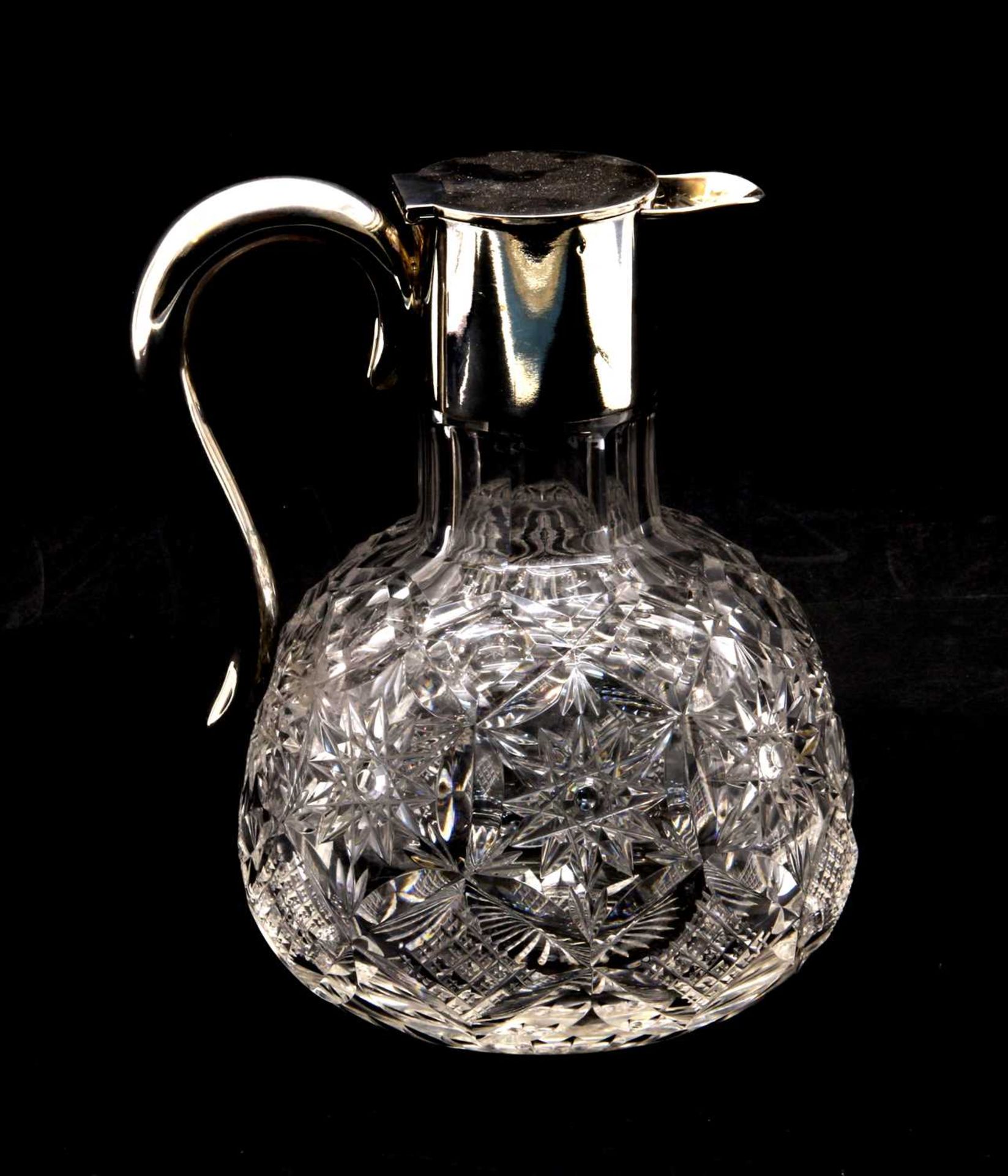 A silver and cut glass jug,