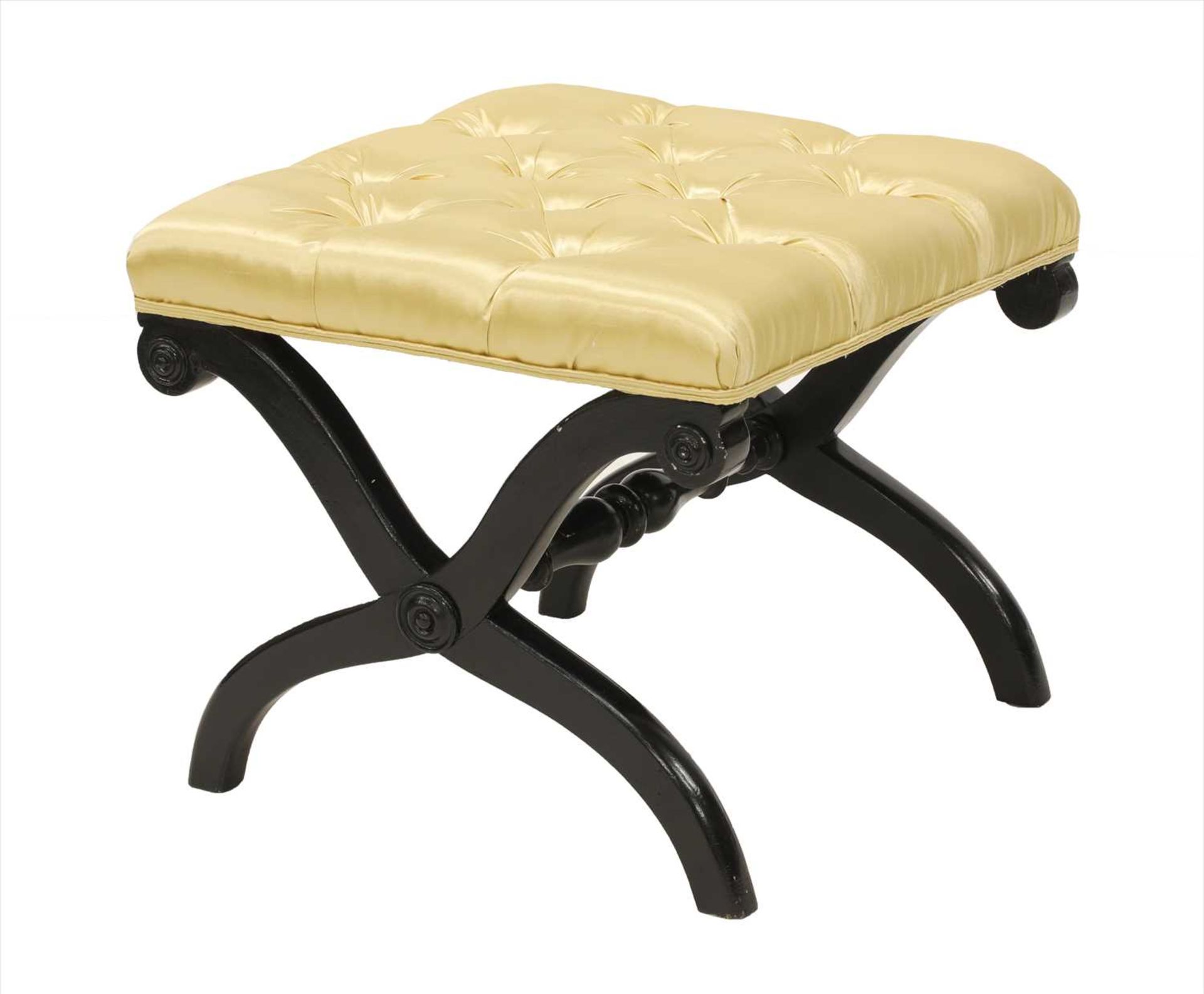 An ebonised and button upholstered stool,