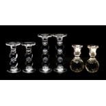 A collection of pairs of glass bobbin form candlesticks,