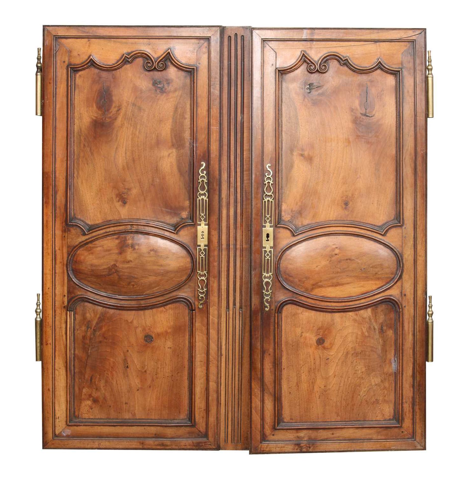 A pair of French chestnut and brass mounted doors,