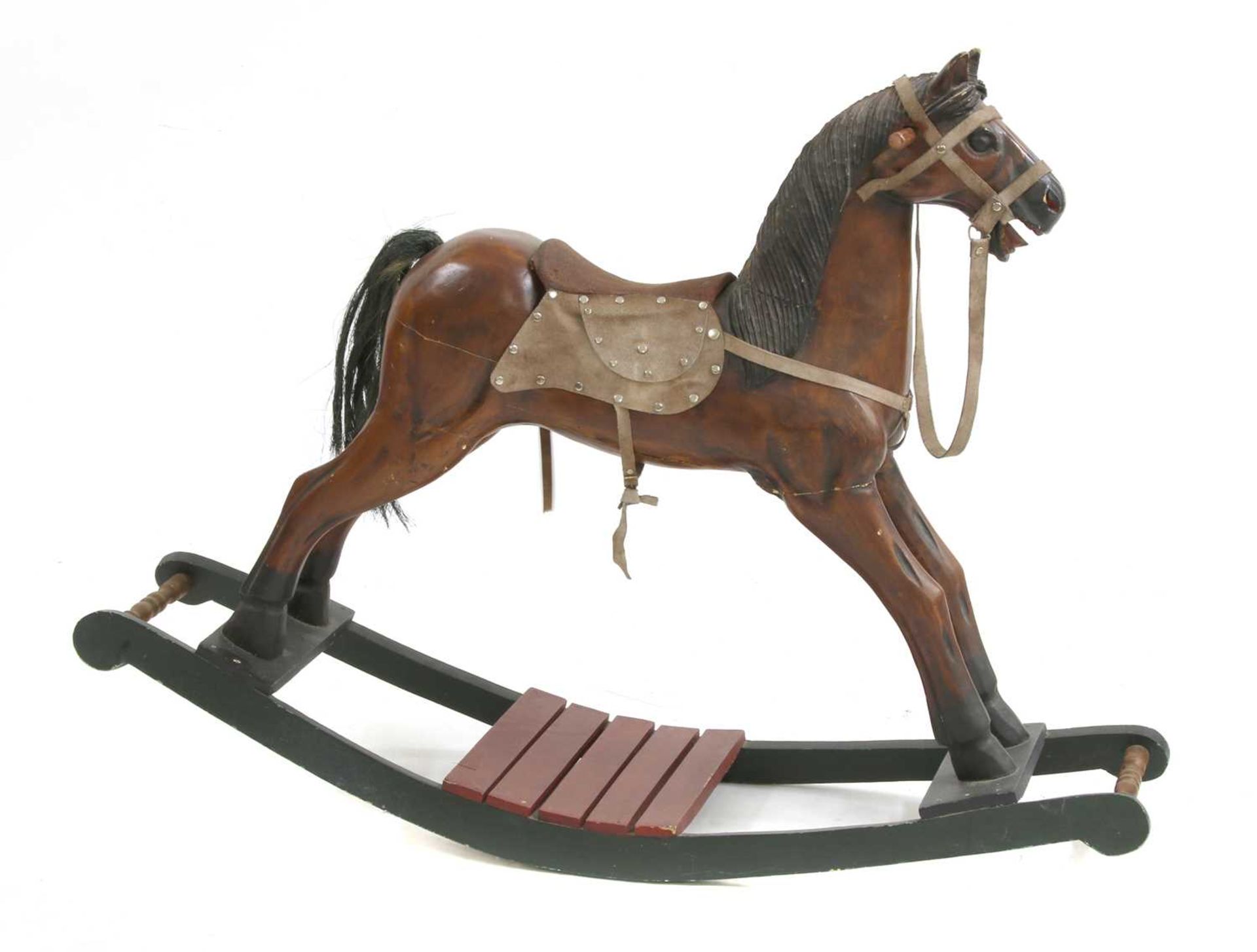 A stained wooden rocking horse,