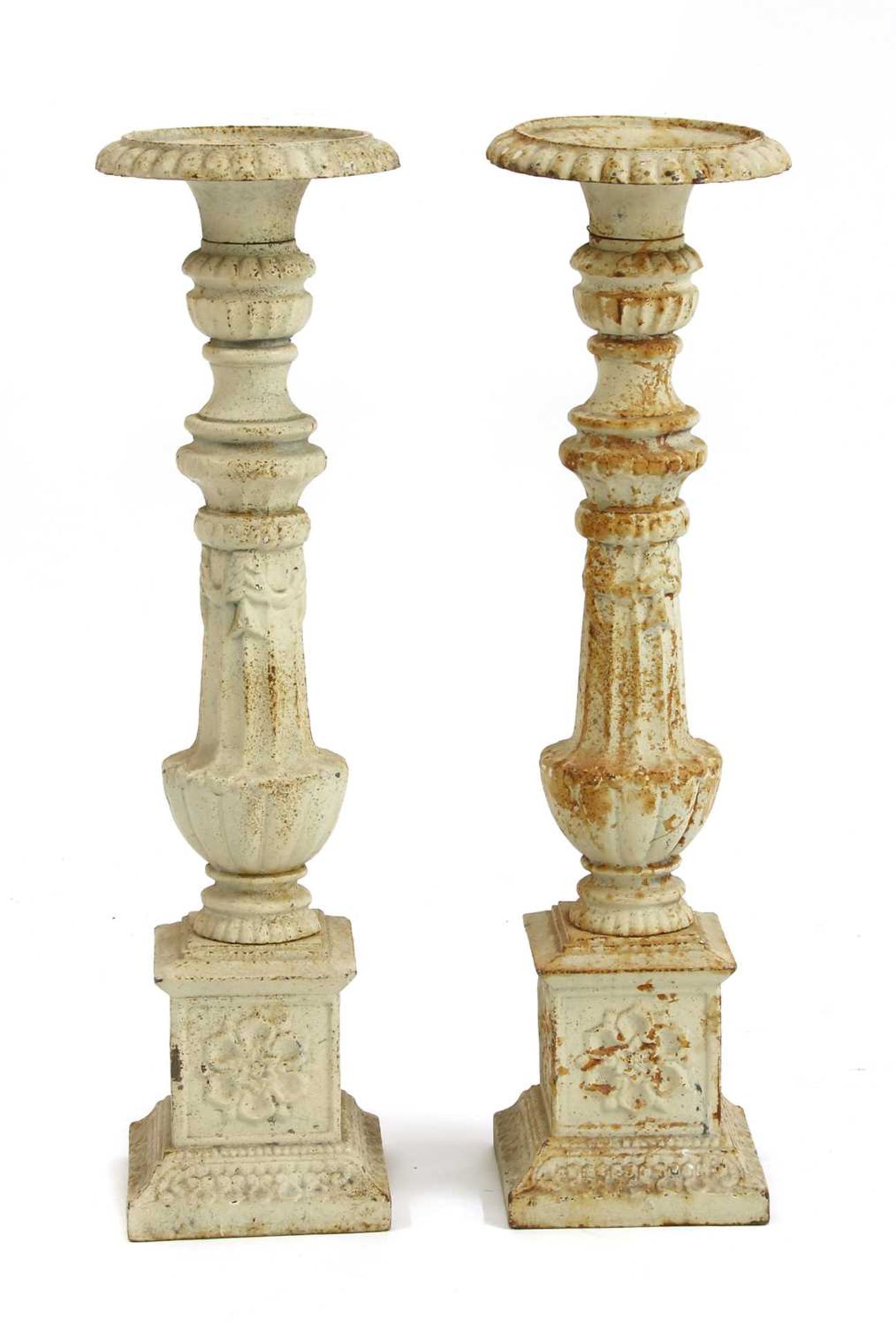 A pair of cast iron pricket candlesticks