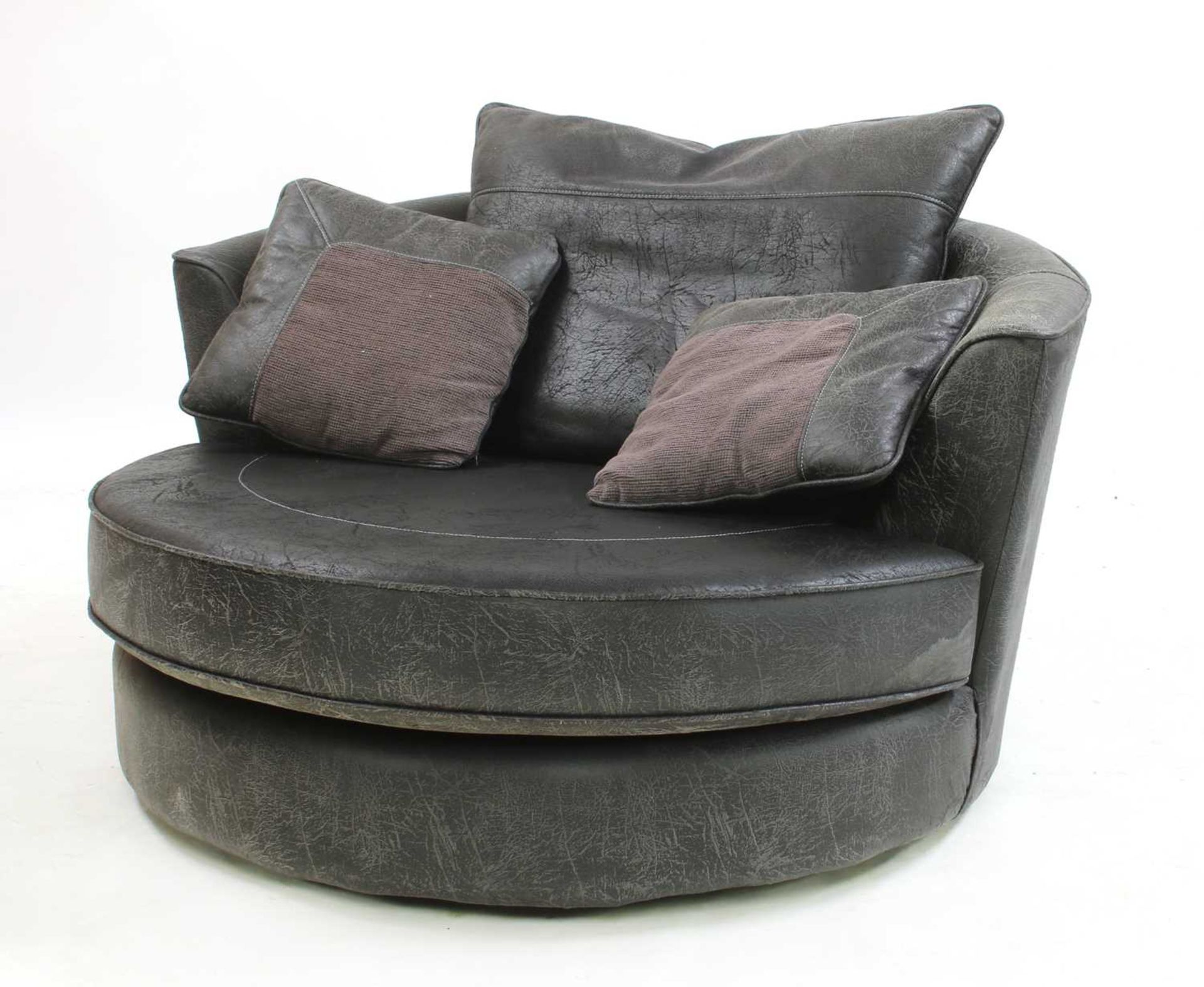 A contemporary brown leather revolving armchair,