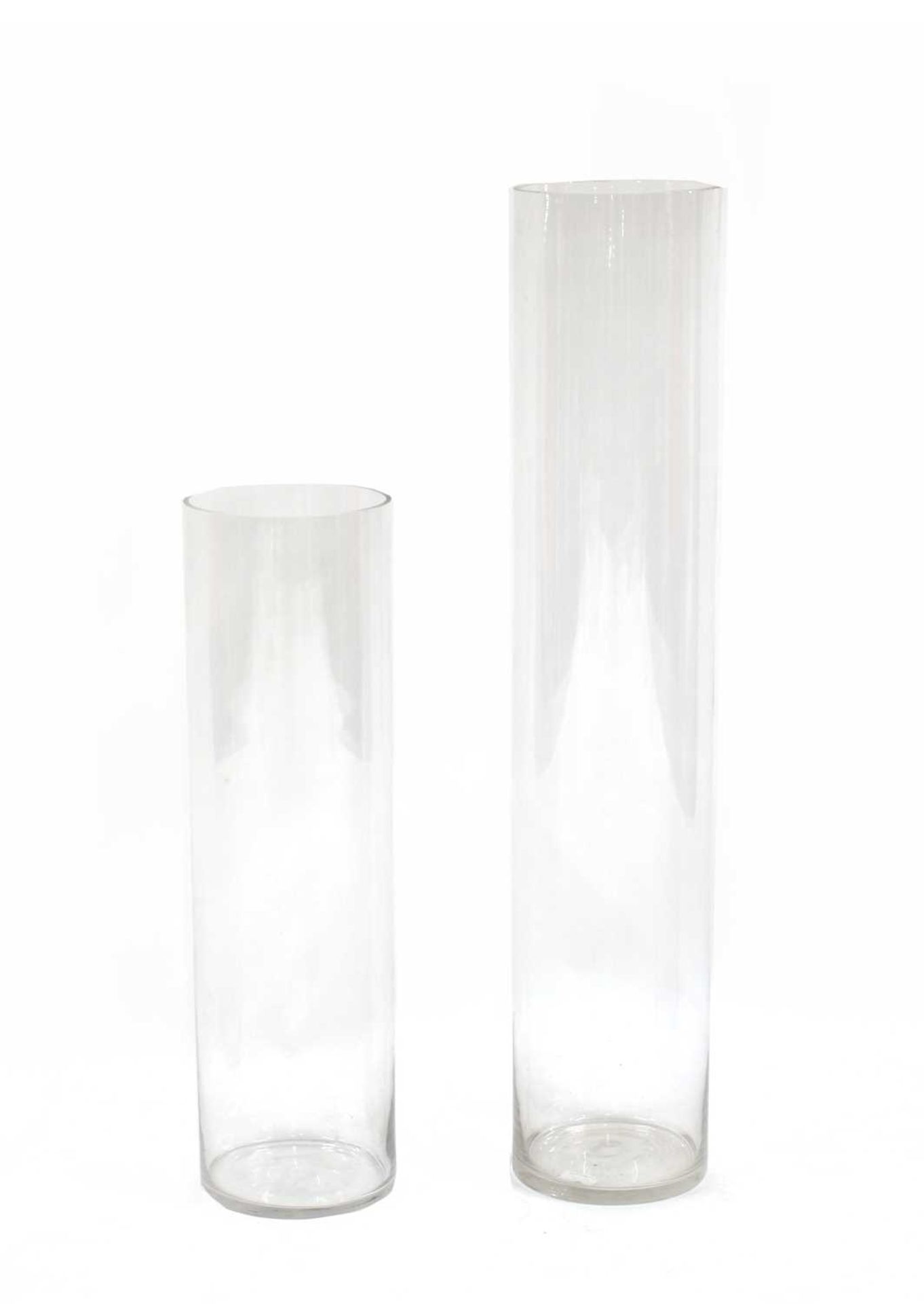 A pair of graduated tall glass vases,