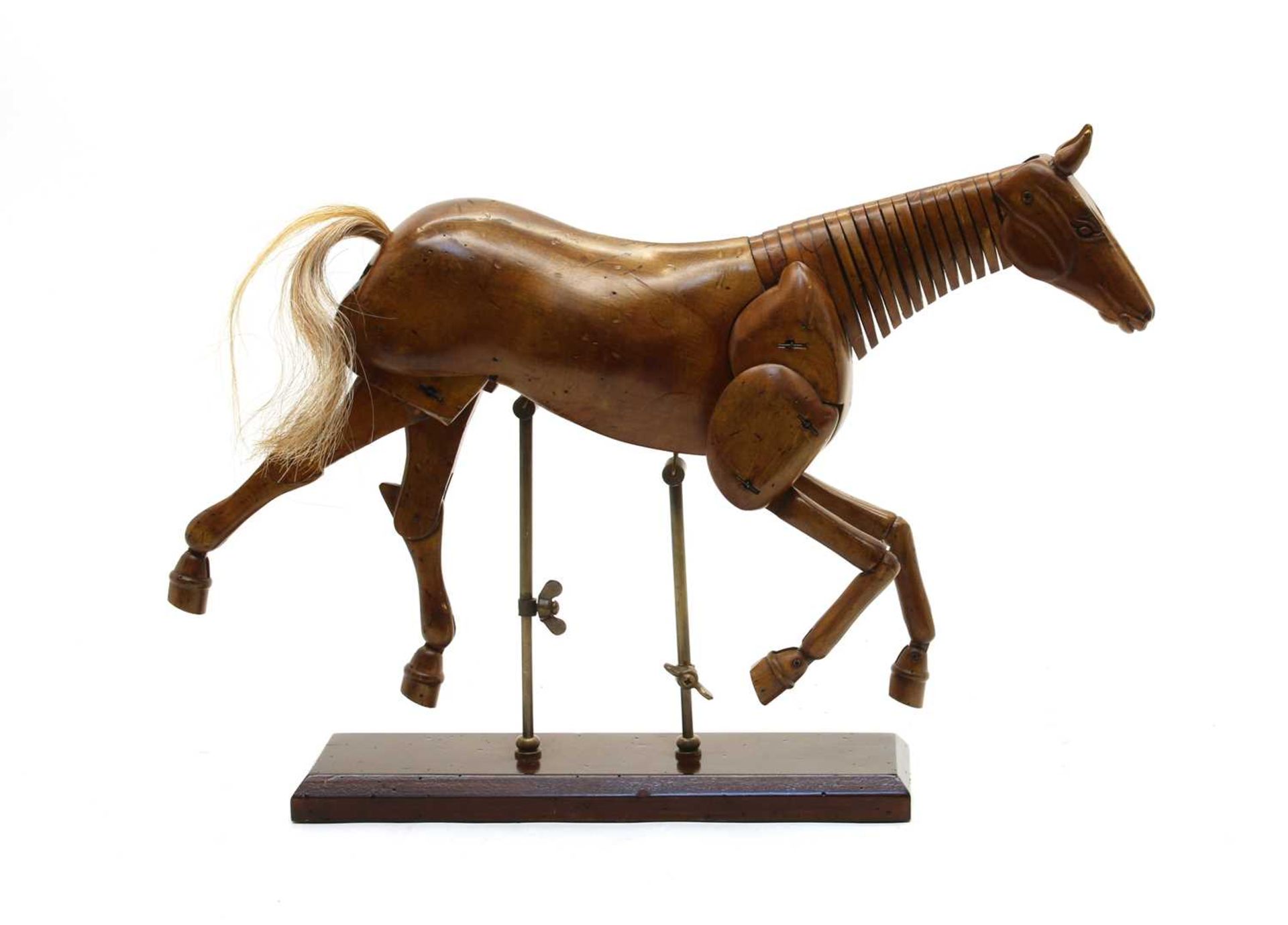 A carved wooden articulated horse