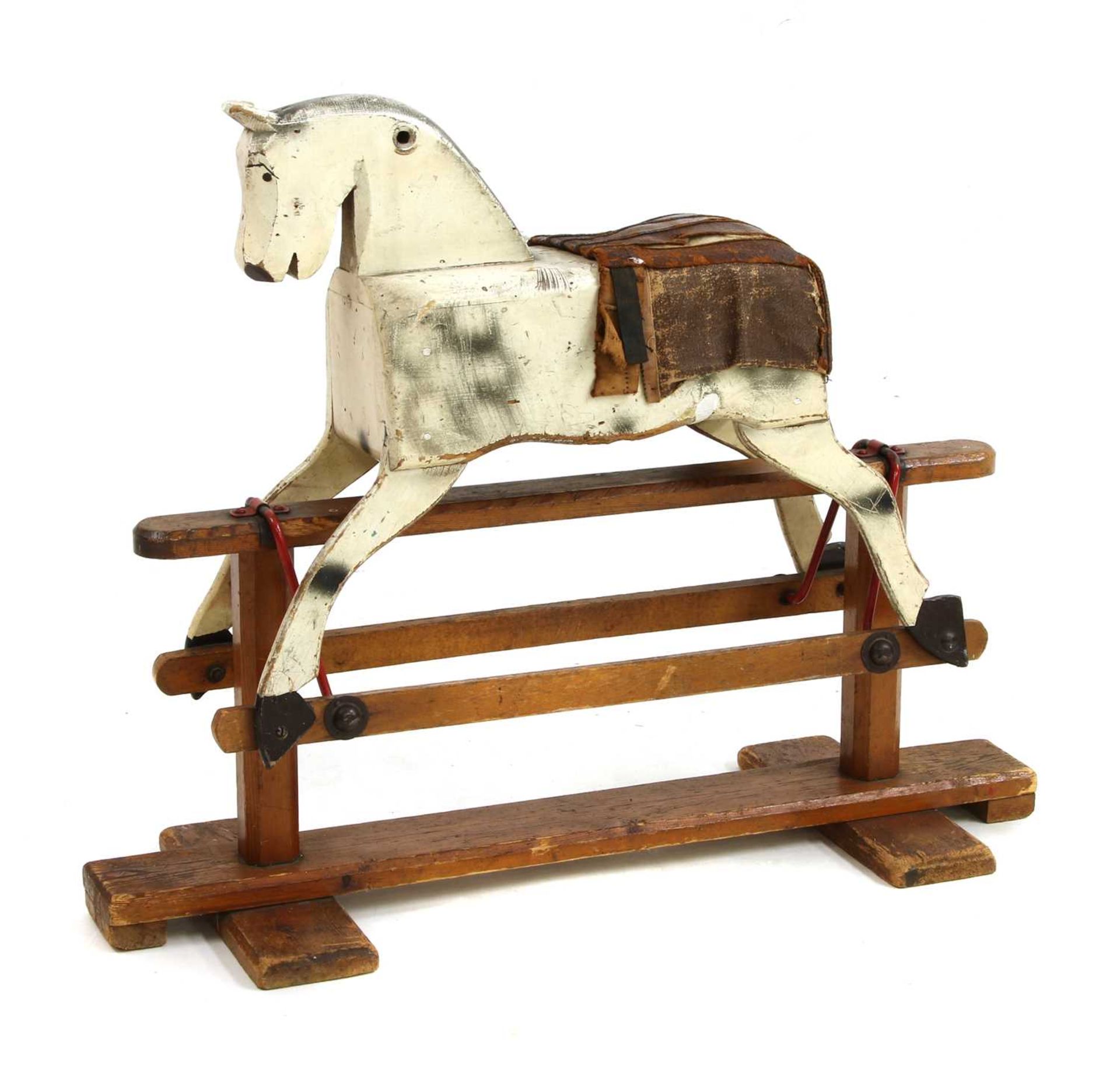 A cream painted wooden rocking horse