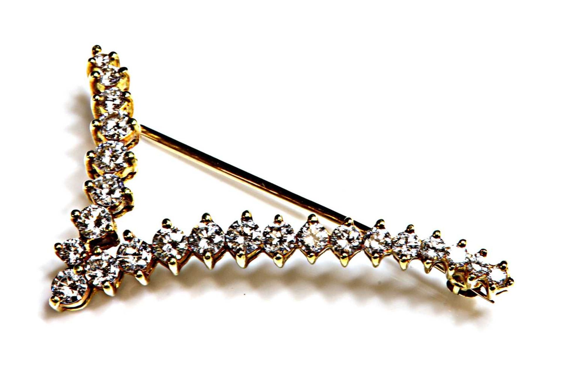 A gold diamond set 'V' or stylised bird in flight brooch,