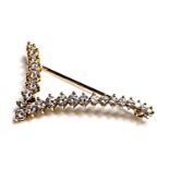 A gold diamond set 'V' or stylised bird in flight brooch,