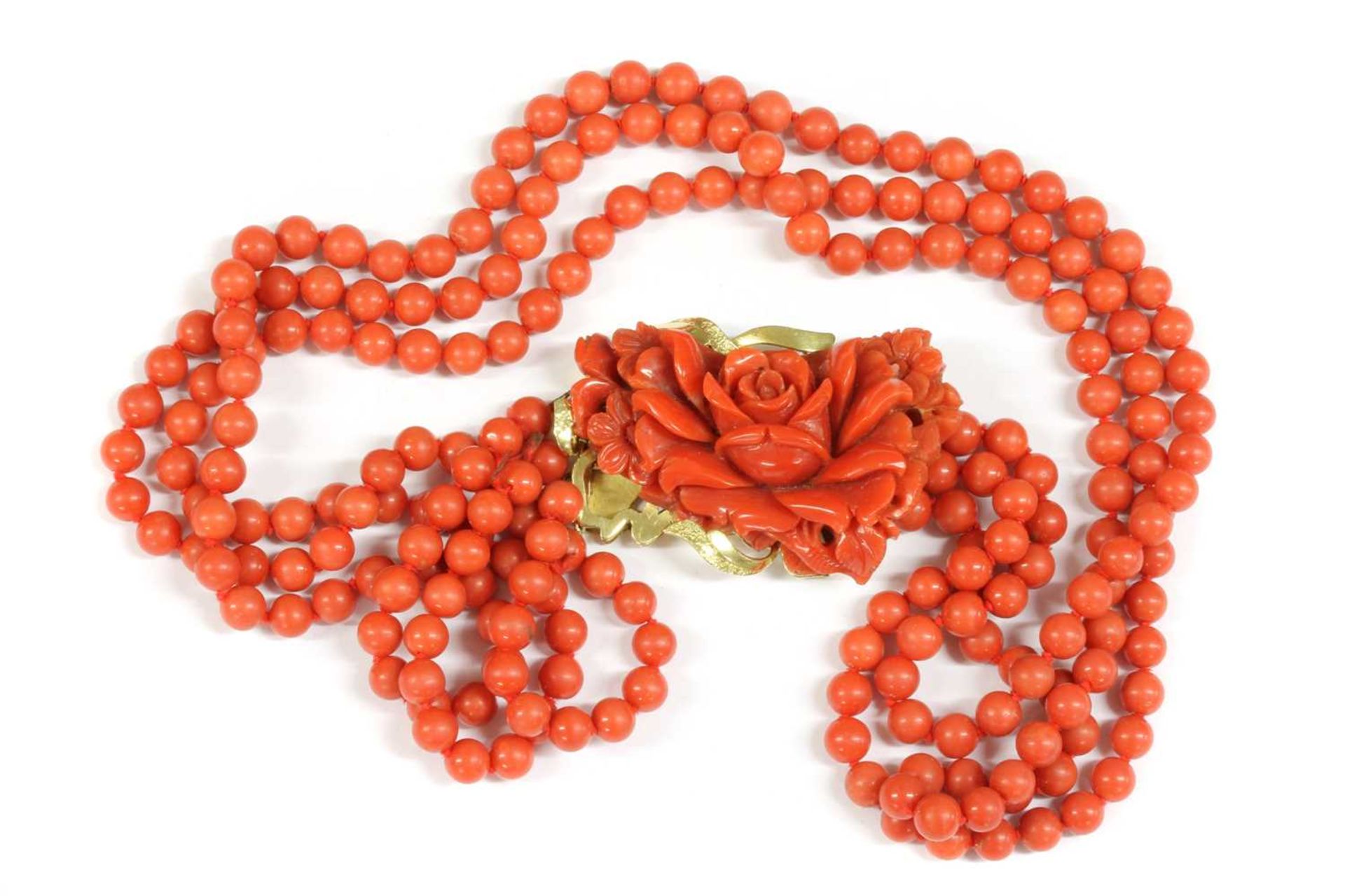 An Italian gold three row uniform coral bead necklace,