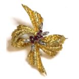 An 18ct gold two colour ruby and diamond bow brooch, c.1950,