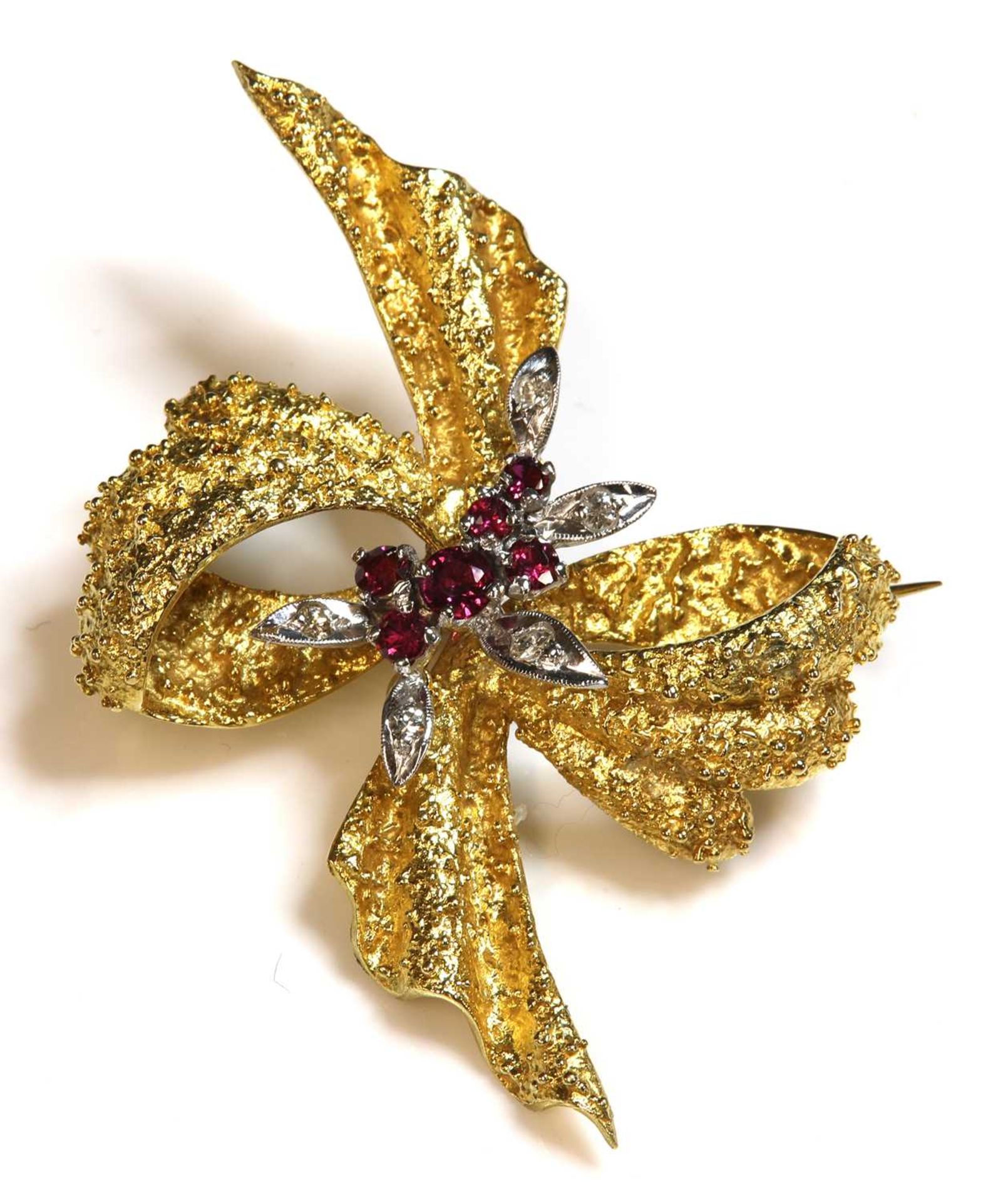 An 18ct gold two colour ruby and diamond bow brooch, c.1950,