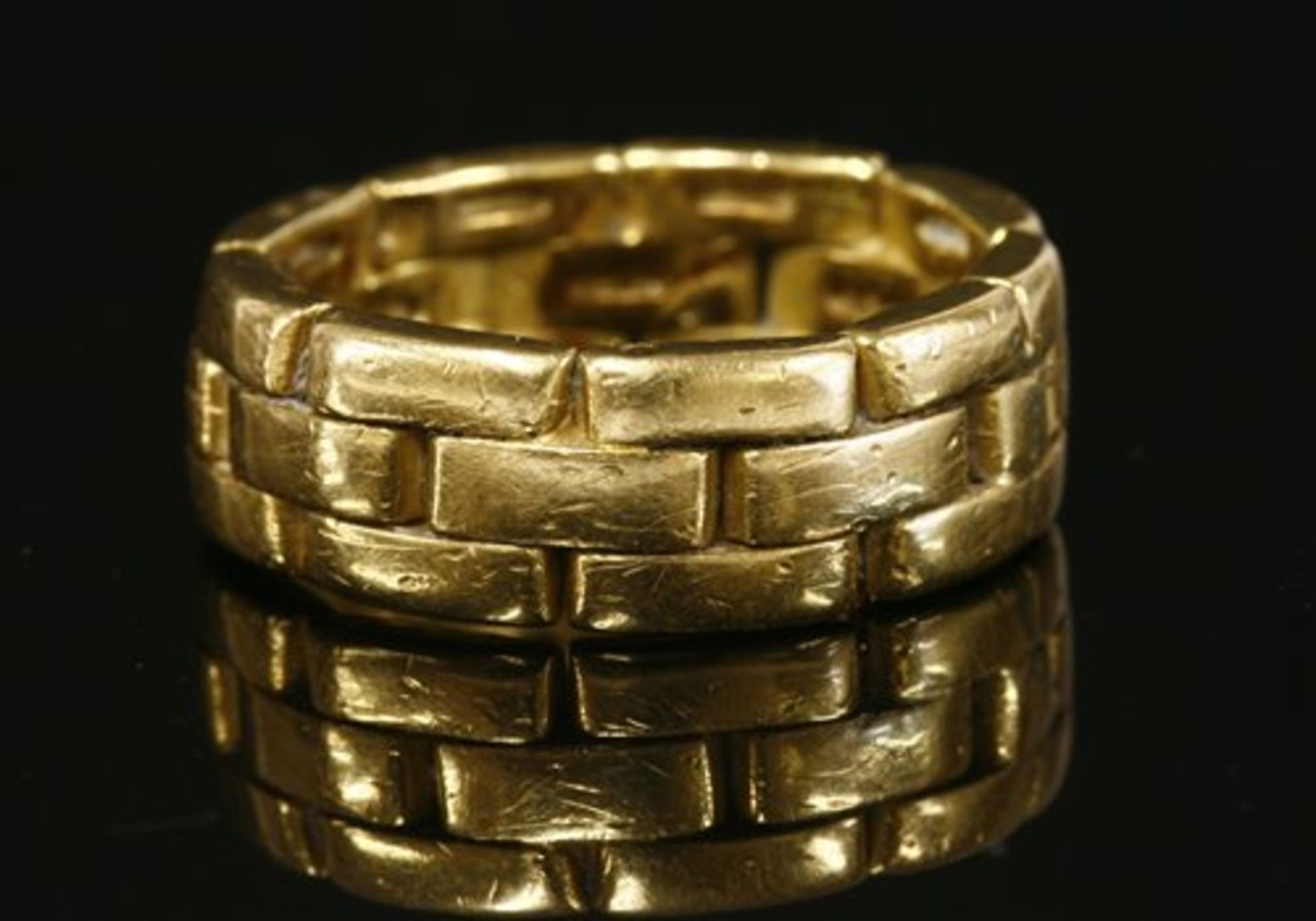 A gold two row brick link or panther chain effect band ring