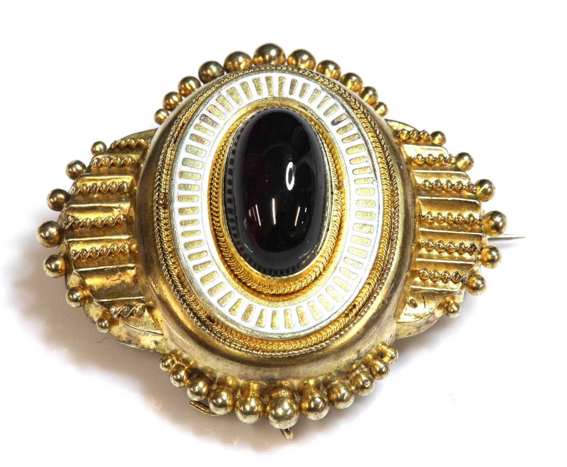 A Victorian Etruscan Revival gold garnet and enamel shield form brooch, c.1860,