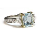 A platinum blue topaz and diamond ring,