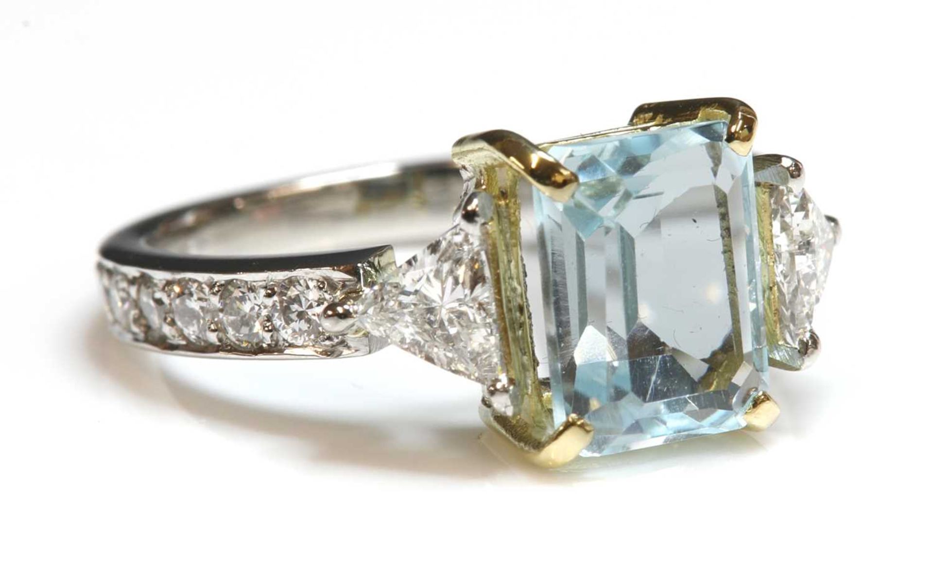 A platinum blue topaz and diamond ring,