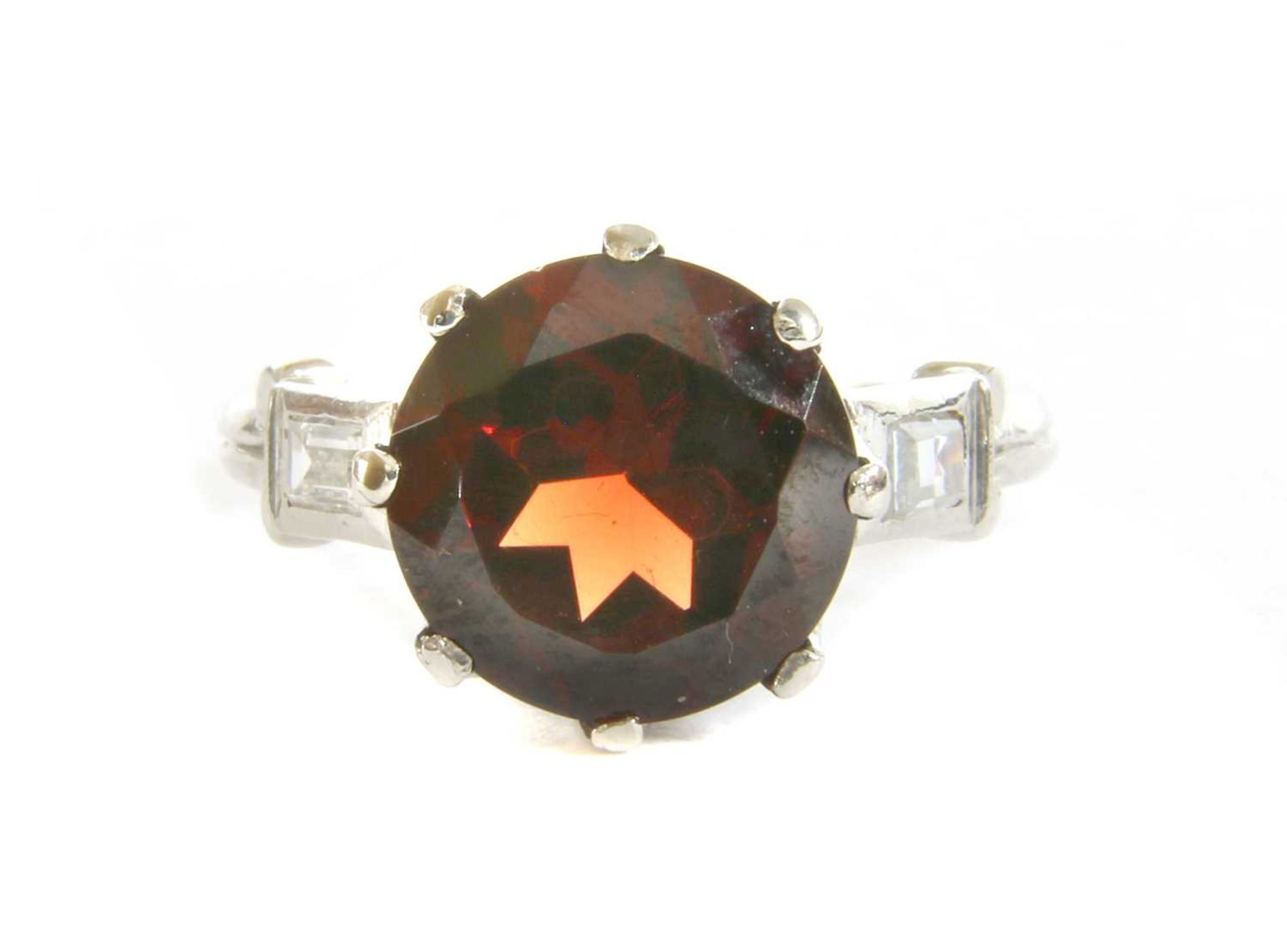 A platinum garnet and diamond ring