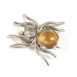 A silver gem set spider brooch,