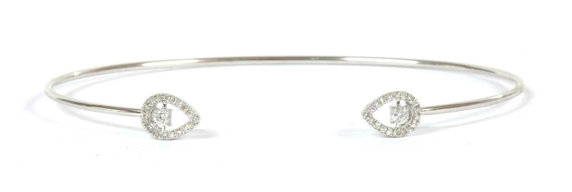 A white gold diamond torque bangle,