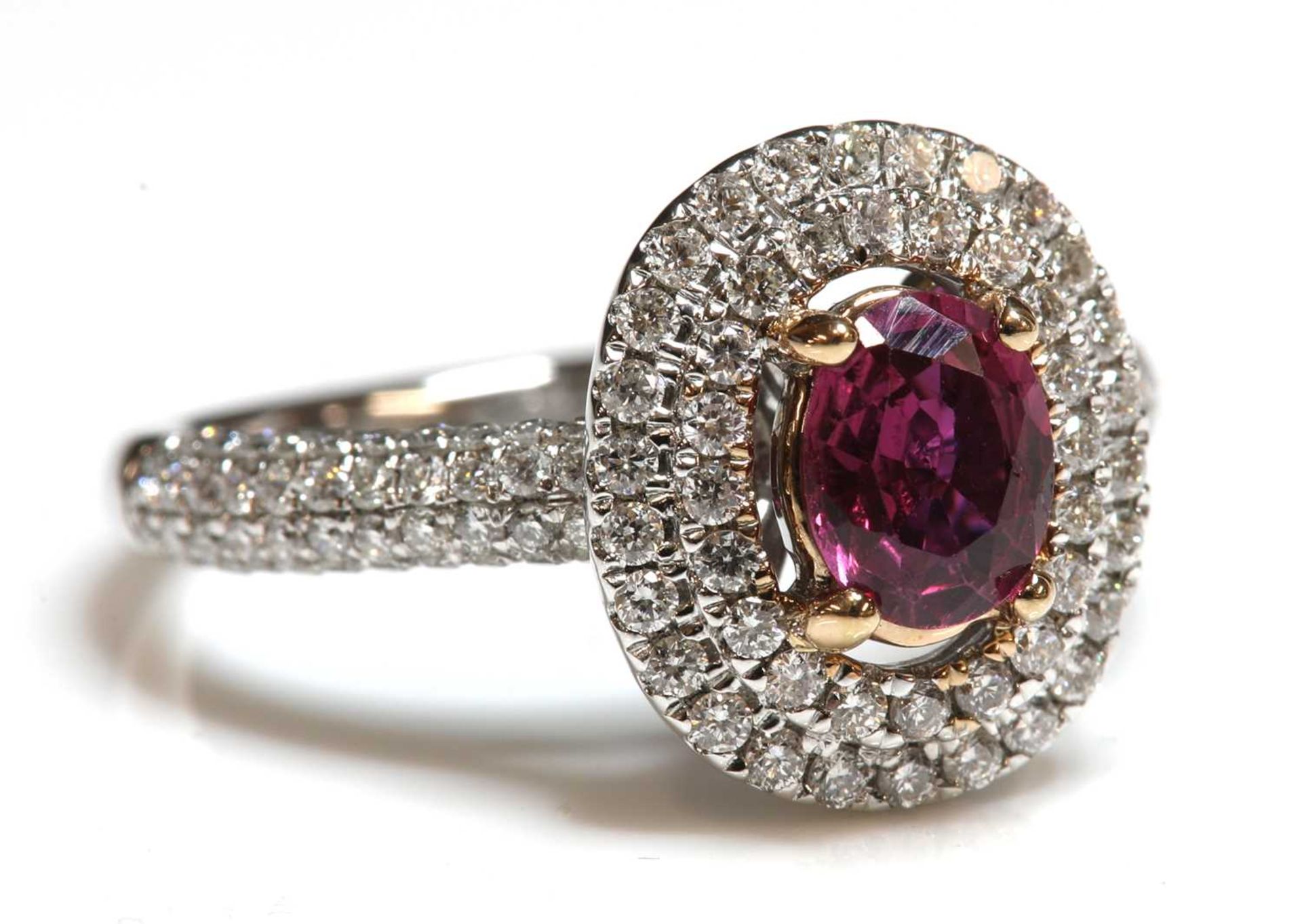 An 18ct rose and white gold, ruby and diamond, two row halo cluster ring,