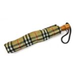 A chequered Burberry umbrella,