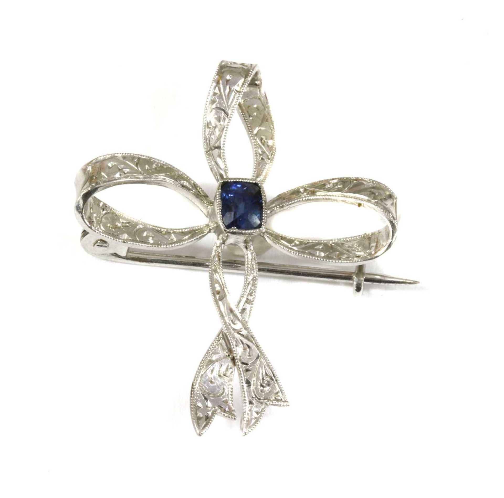 An Edwardian white gold sapphire bow brooch,