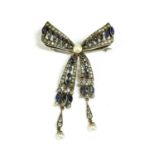 A silver paste bow brooch,