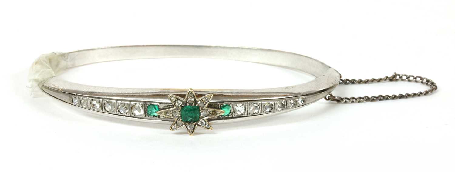 A Continental emerald and diamond set hinged bangle,