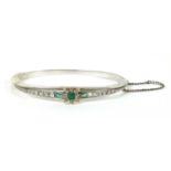 A Continental emerald and diamond set hinged bangle,