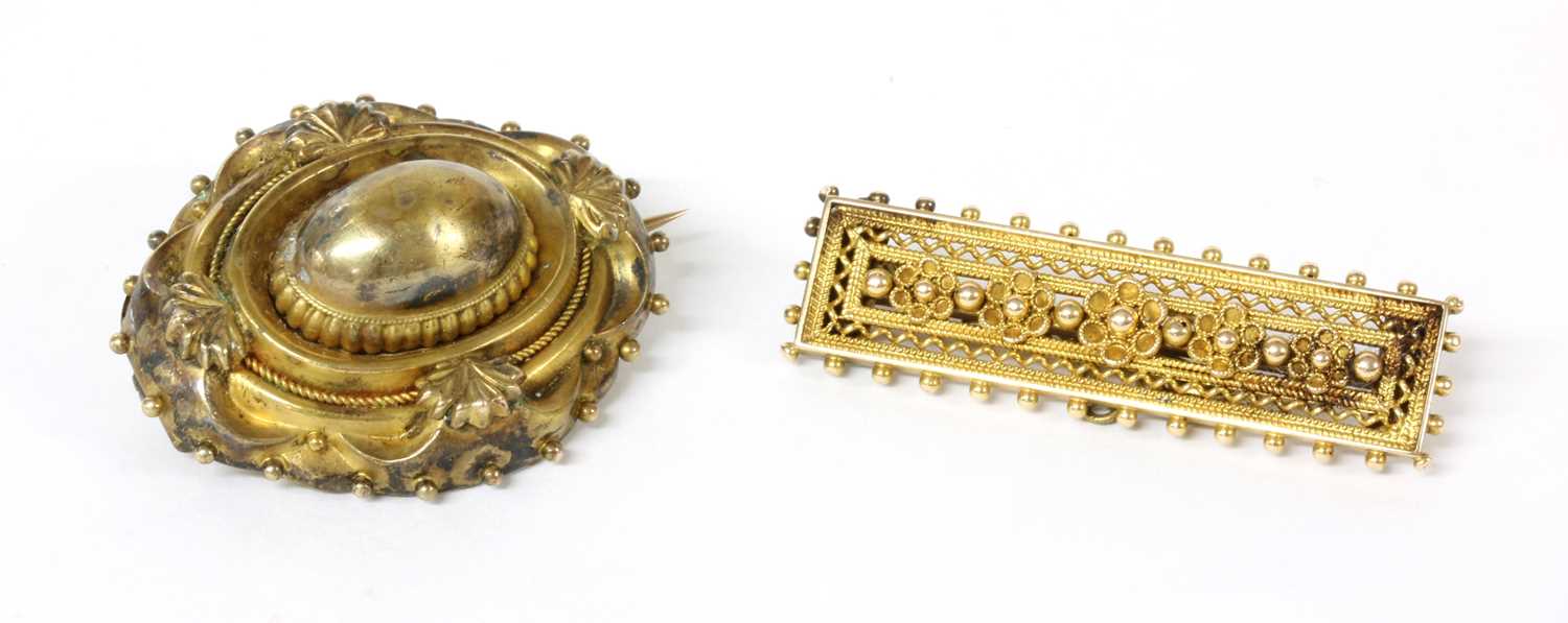 A Victorian Etruscan Revival gold shield form brooch,