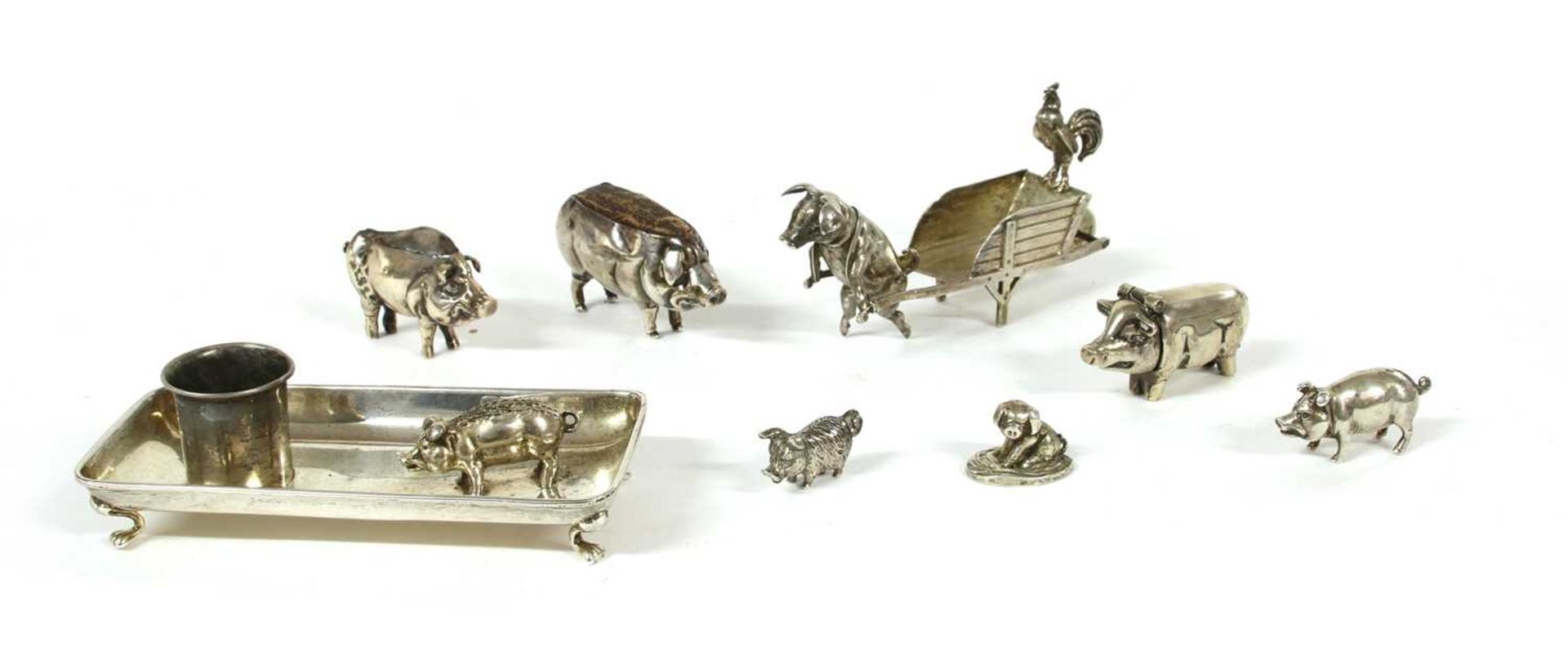 A collection of silver pig novelties,