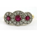 An 18ct gold ruby and diamond triple cluster ring,