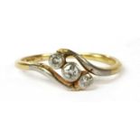 A gold three stone diamond ring,
