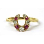 A gold diamond and ruby horseshoe ring,