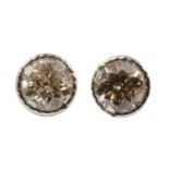 A pair of white gold diamond stud earrings,