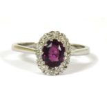 An 18ct white gold purple sapphire and diamond cluster ring,