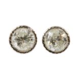 A pair of white gold diamond stud earrings,