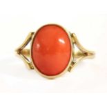 A gold single stone coral ring,
