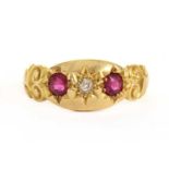 An 18ct gold three stone diamond and ruby set ring,