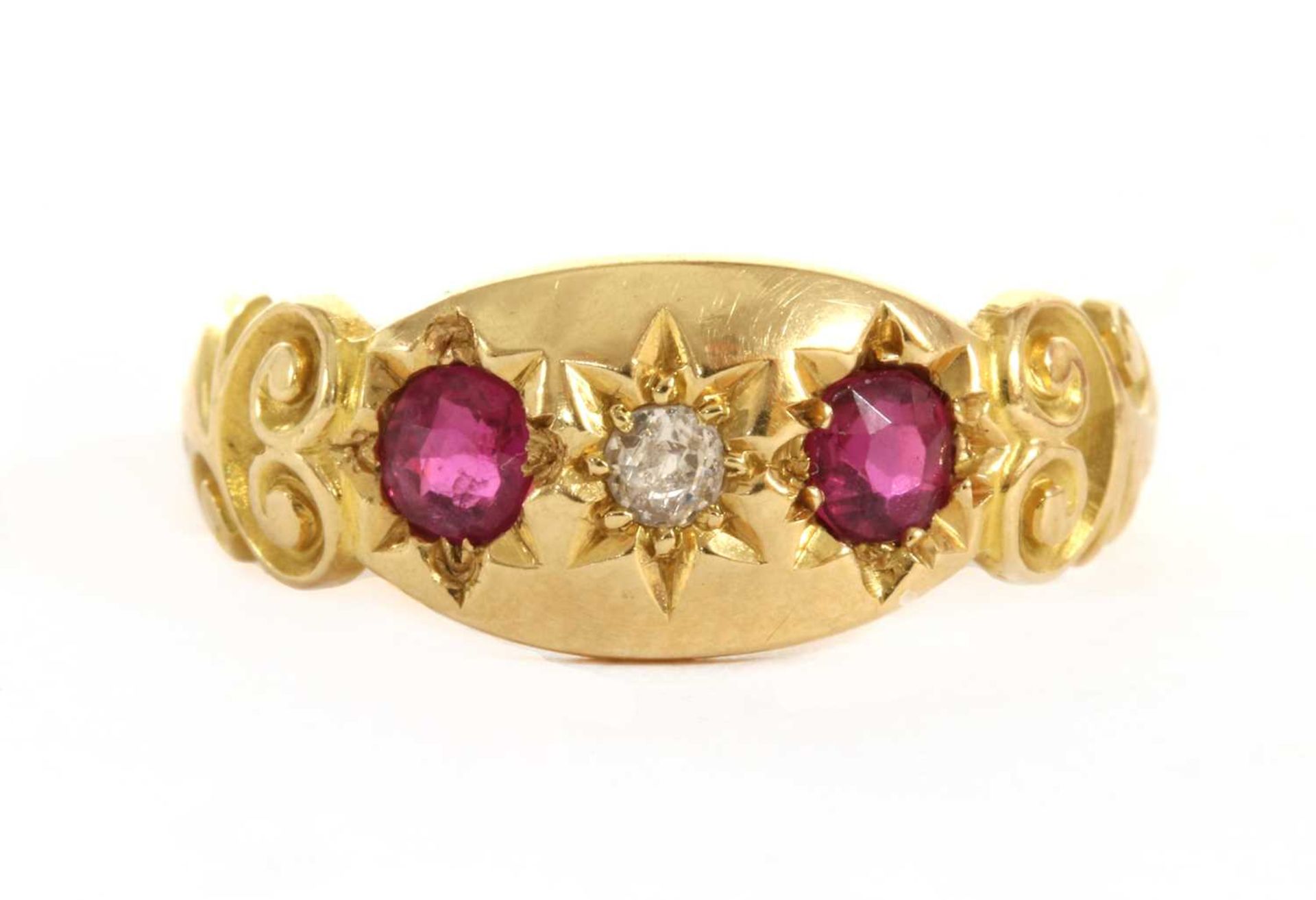 An 18ct gold three stone diamond and ruby set ring,