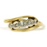 A gold five stone diamond crossover ring,