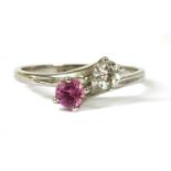 An 18ct white gold diamond and pink sapphire crossover ring,