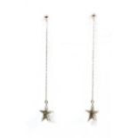 A pair of white gold diamond set star drop earrings,