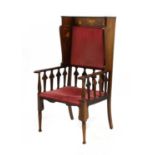 A mahogany inlaid wingback armchair,