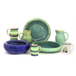 Five Ashtead Potters' jugs and a mug,